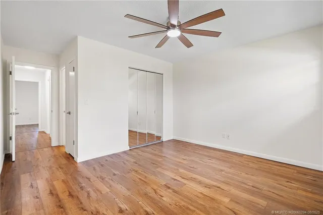 a view of empty room with wooden floor