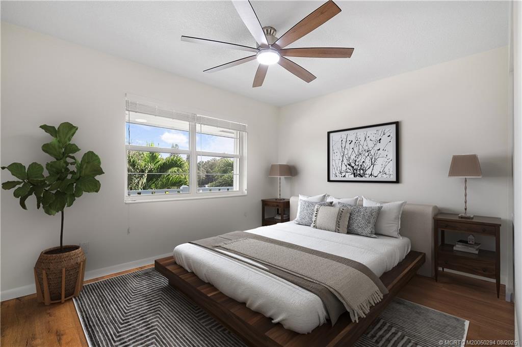 2929 Southeast Ocean Boulevard, Unit 1087 Stuart, FL 34996 - Photo 16 of 21 a bedroom with a large bed and a potted plant