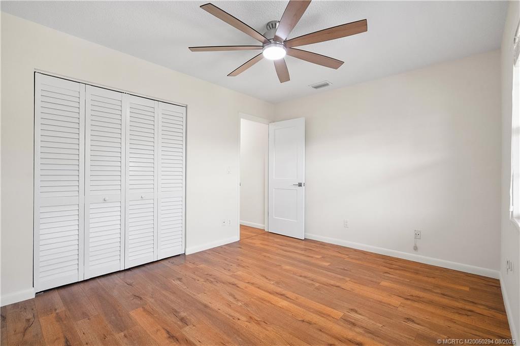 2929 Southeast Ocean Boulevard, Unit 1087 Stuart, FL 34996 - Photo 17 of 21 a view of empty room with wooden floor and fan