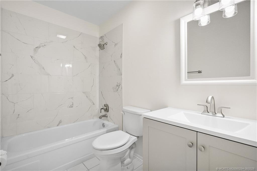 2929 Southeast Ocean Boulevard, Unit 1087 Stuart, FL 34996 - Photo 18 of 21 a bathroom with a sink a toilet and a bathtub