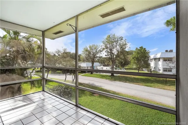 a view of a balcony with yard