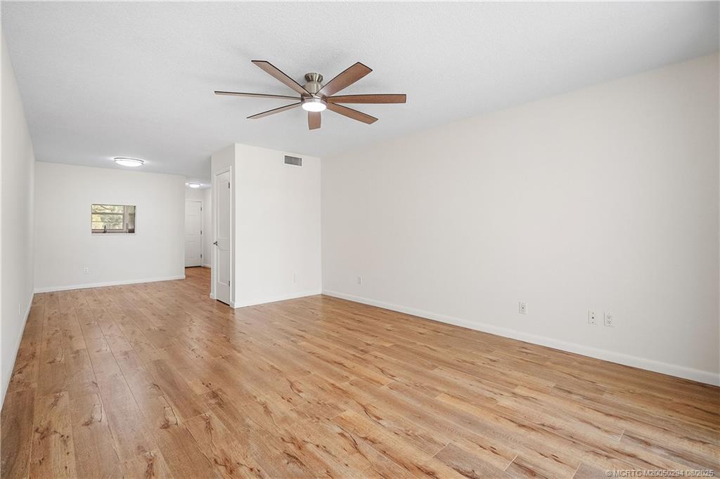2929 Southeast Ocean Boulevard, Unit 1087 Stuart, FL 34996 - Photo 9 of 21 a view of a big room with wooden floor and windows