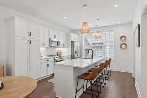 a kitchen with stainless steel appliances a stove microwave and refrigerator