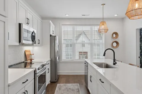 a kitchen with cabinets and window