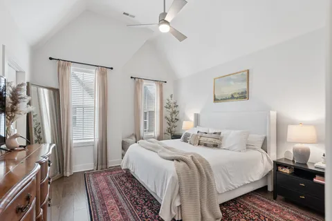 a bedroom with a large bed and a chandelier