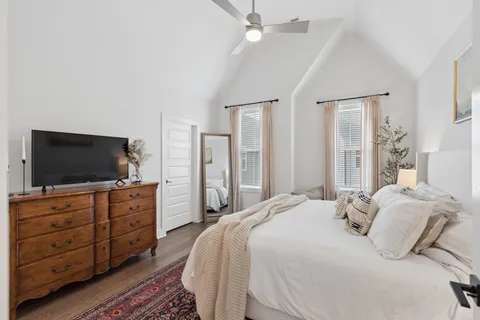 a bedroom with a bed and a chandelier