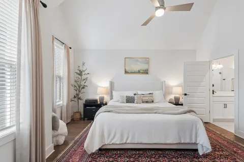 a bedroom with bed and a chandelier