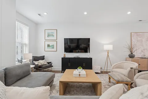 a living room with furniture and wooden floor
