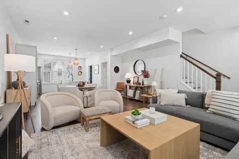 a dining room with furniture a wooden floor and a chandelier