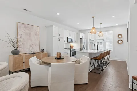 a kitchen with stainless steel appliances granite countertop a sink a stove a refrigerator and island