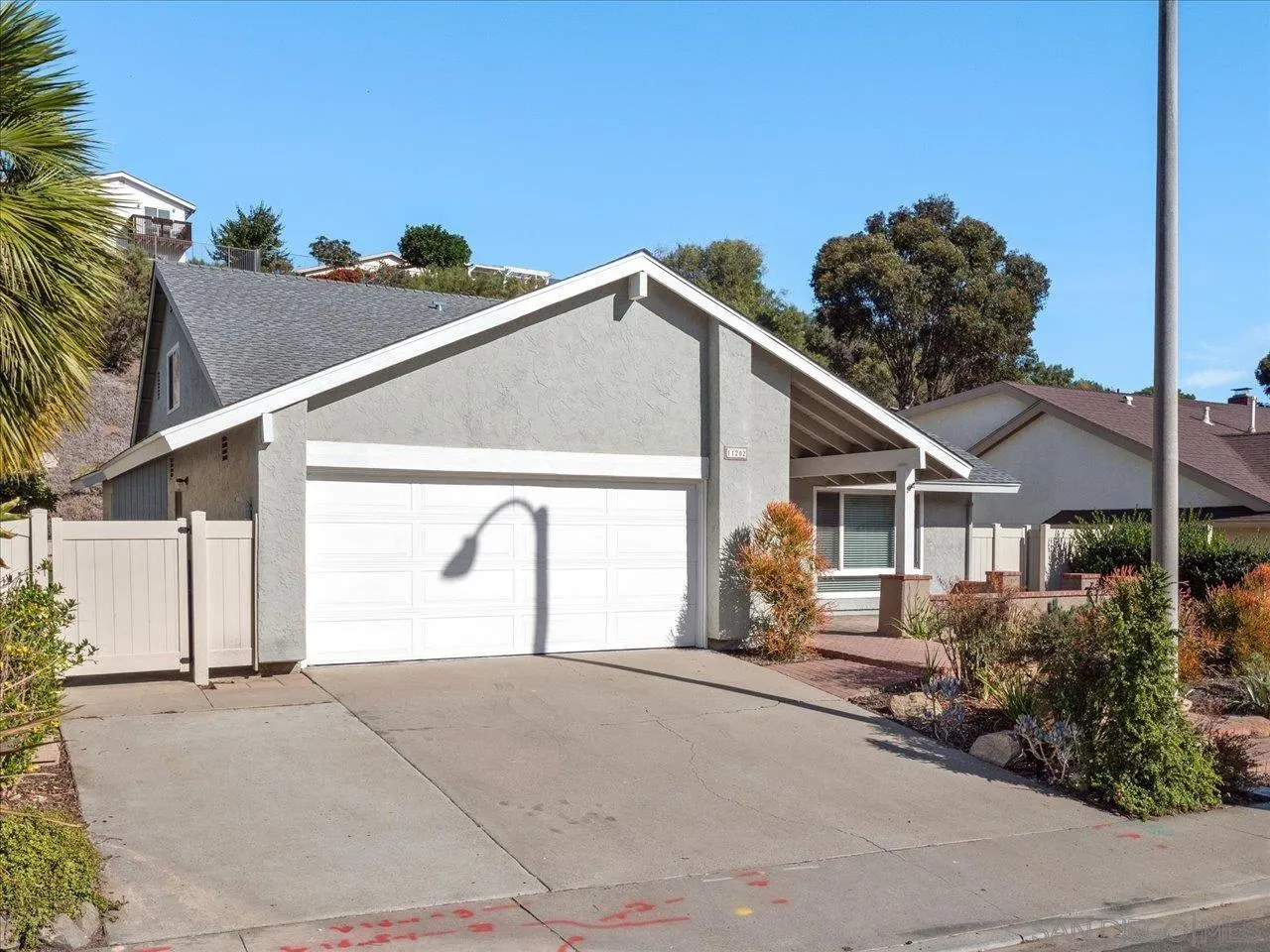 a house with a yard and a large parking space
