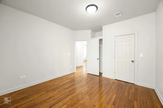 an empty room with wooden floor