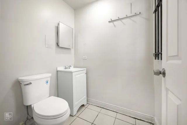 a white toilet sitting next to a bathroom sink