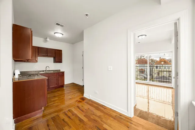 a view of kitchen with stainless steel appliances granite countertop a stove top oven a sink and a granite counter top