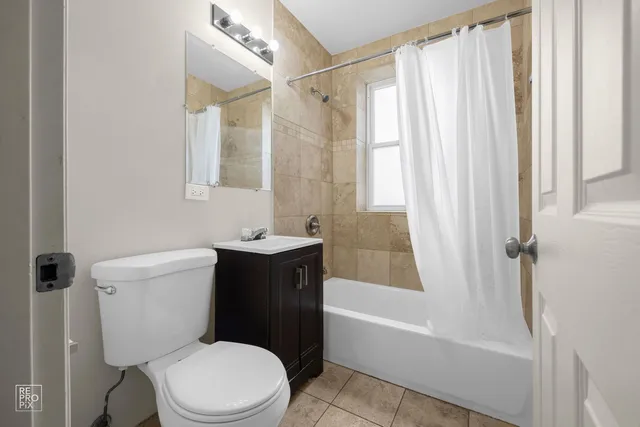 a white toilet sitting next to a bath tub shower