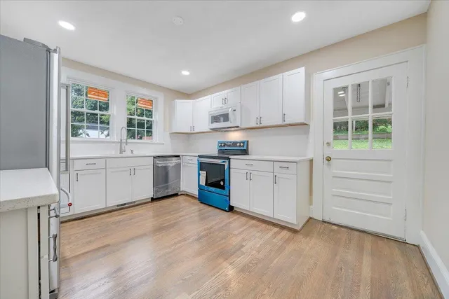 a kitchen with a sink window and cabinets