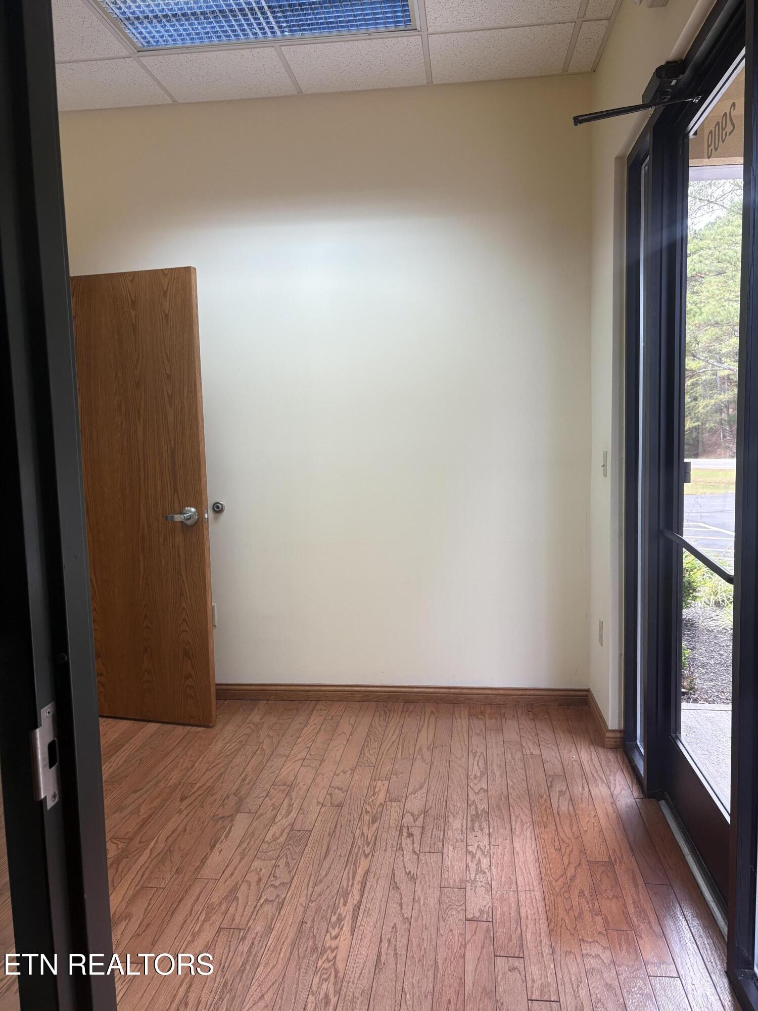 2909 Decatur Highway Kingston, TN 37763 - Photo 4 of 16 an empty room with wooden floor and windows