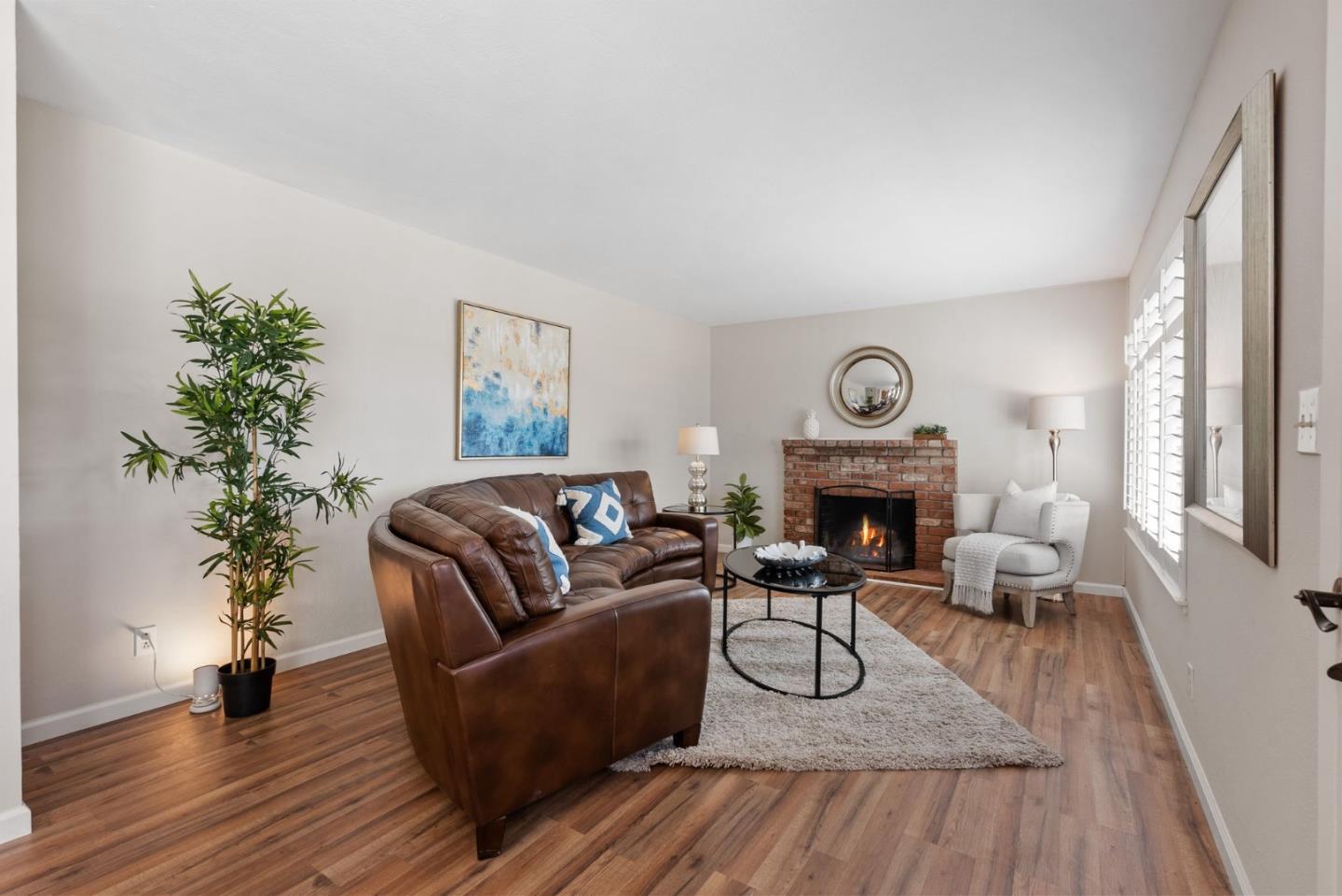 254 Uvas Street Milpitas, CA 95035 - Photo 15 of 48 a living room with furniture a fireplace and potted plants