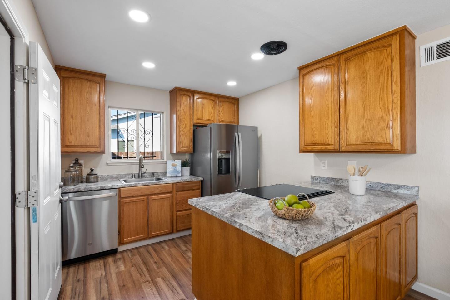 254 Uvas Street Milpitas, CA 95035 - Photo 22 of 48 a kitchen with stainless steel appliances granite countertop sink stove and refrigerator