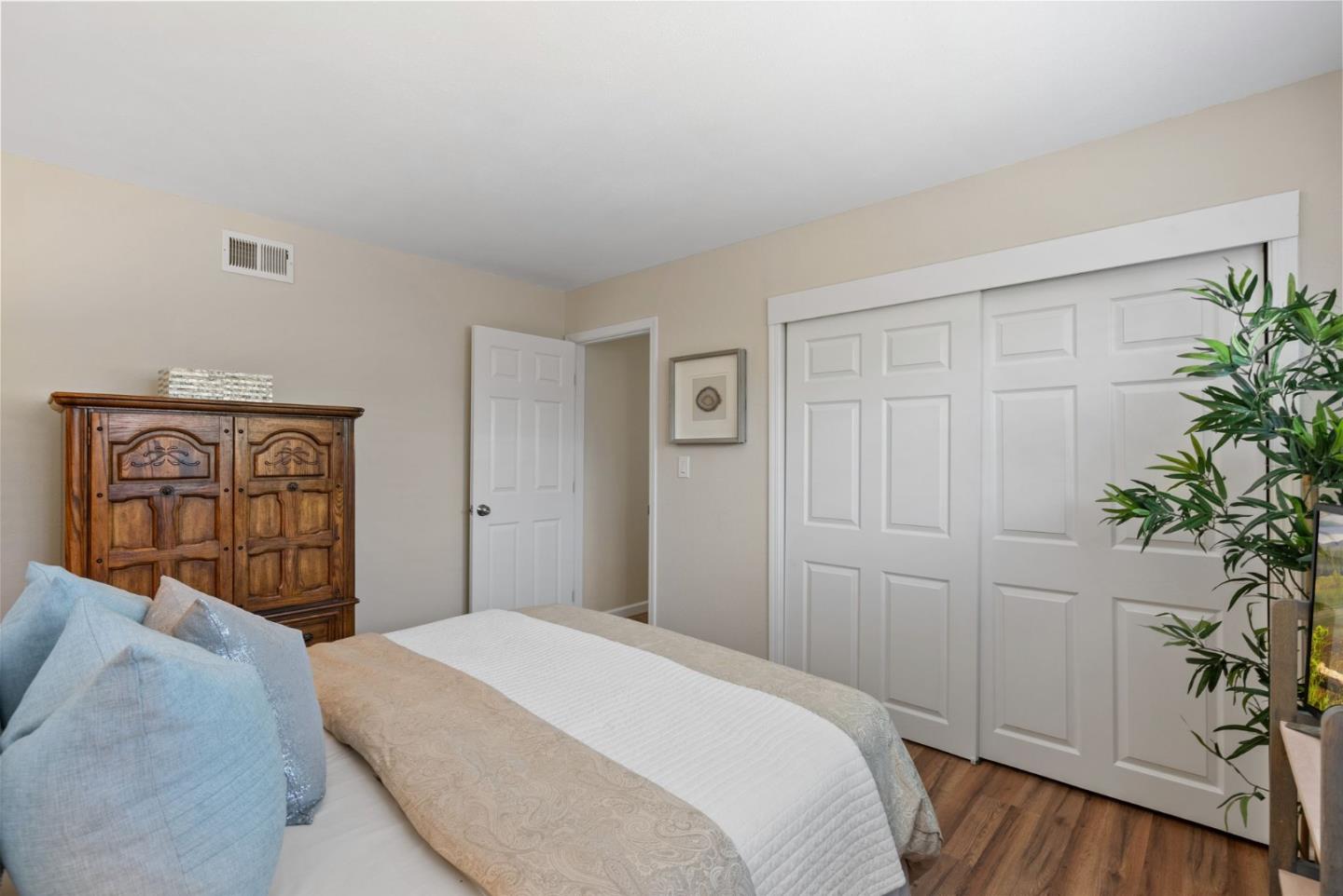 254 Uvas Street Milpitas, CA 95035 - Photo 32 of 48 a bedroom with a bed and a potted plant