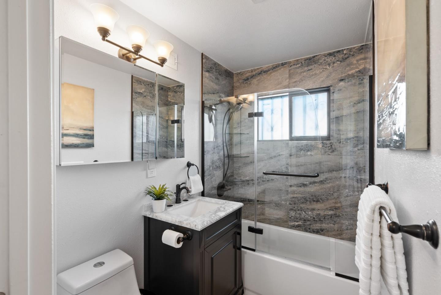 254 Uvas Street Milpitas, CA 95035 - Photo 35 of 48 a bathroom with a granite countertop sink a toilet and shower