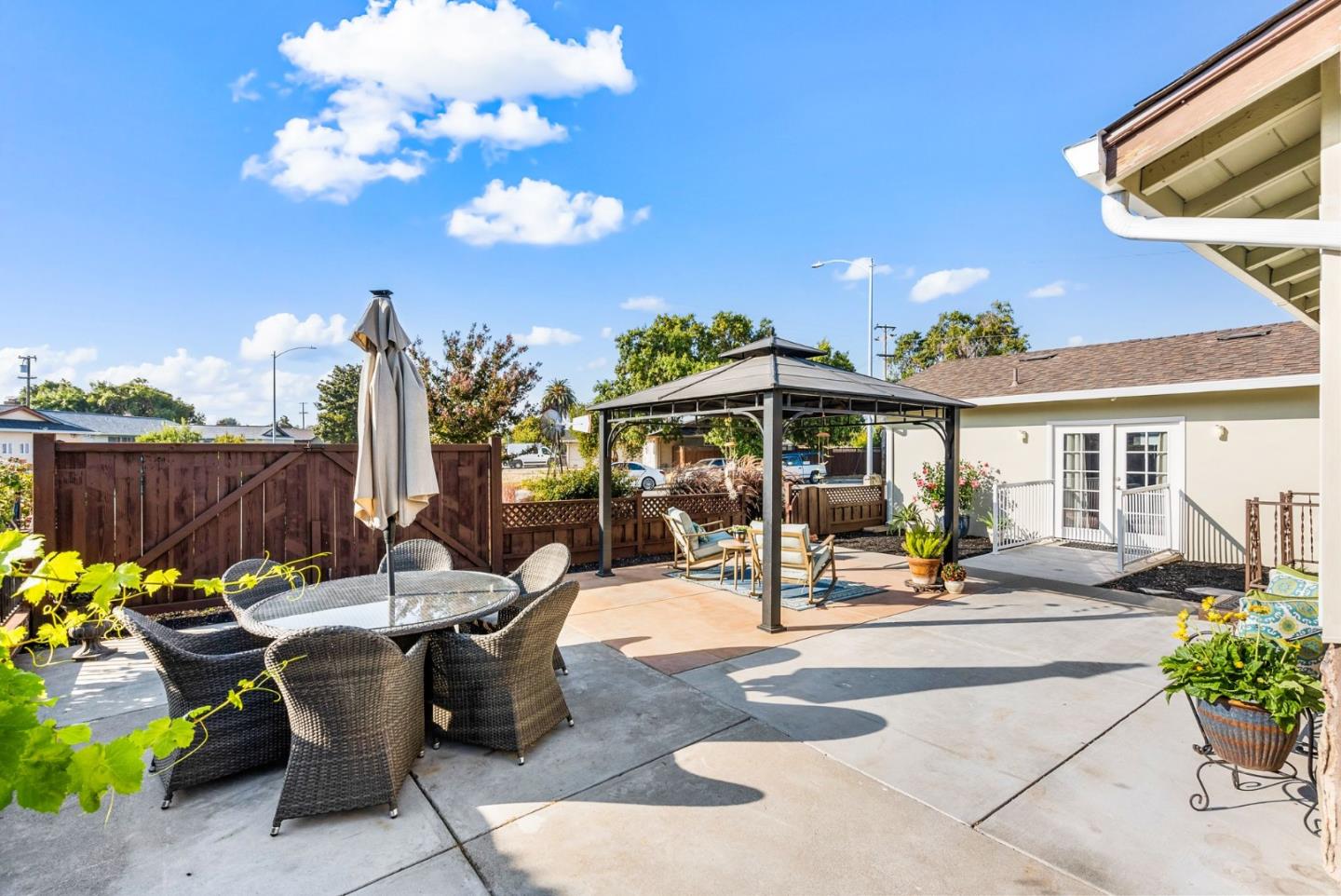 254 Uvas Street Milpitas, CA 95035 - Photo 8 of 48 a view of a patio with dining table and chairs under an umbrella