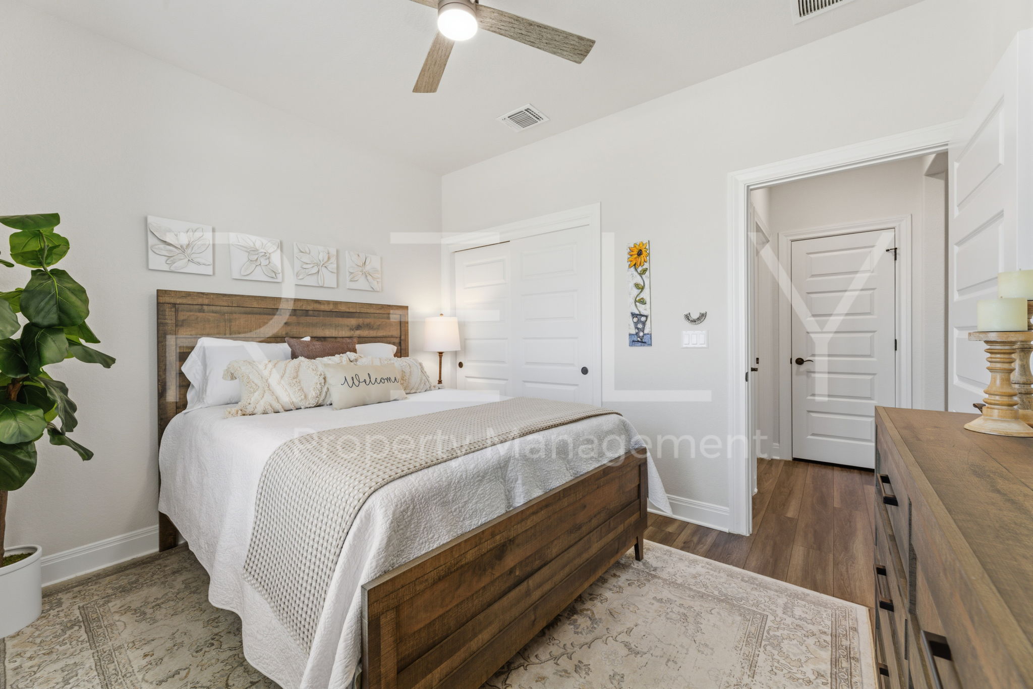 101 Spanish Star Street Georgetown, TX 78633 - Photo 30 of 39 Comfortable sleeping space featuring wood flooring, a ceiling fan, and ample closet storage.