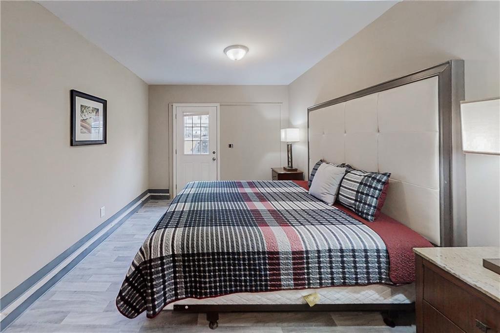 2284 Emerald Springs Drive Decatur, GA 30035 - Photo 27 of 30 a bedroom with a bed and wooden floor