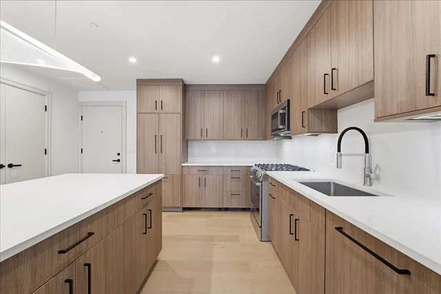 a kitchen with a sink stove and cabinets