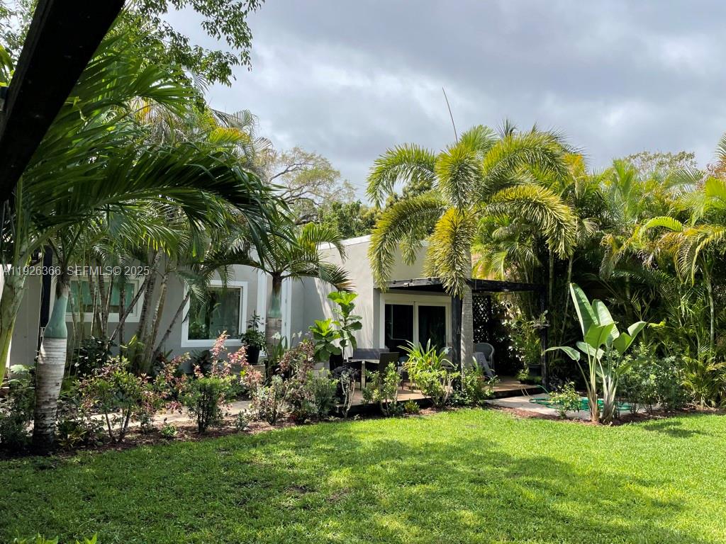 a front view of house with yard and green space