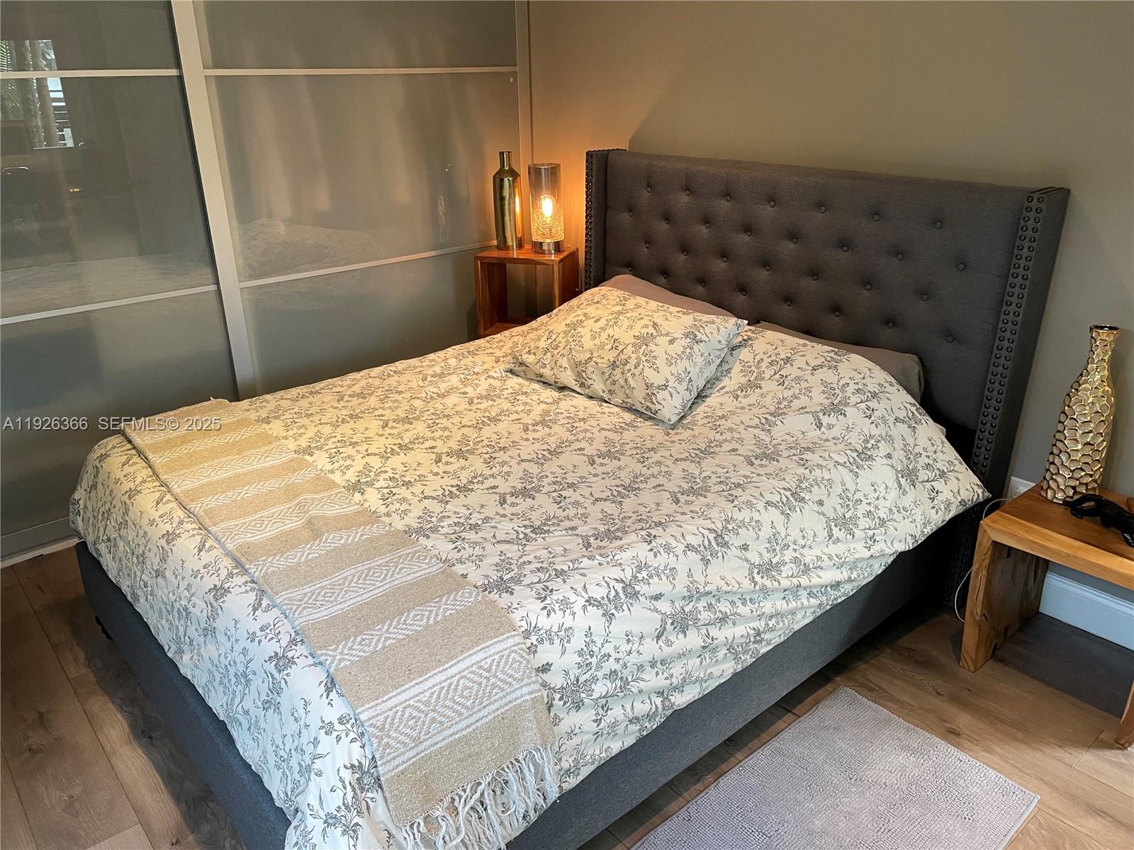 2654 Southwest 25th Terrace Miami, FL 33133 - Photo 16 of 36 a bed sitting in a bedroom next to a larger window