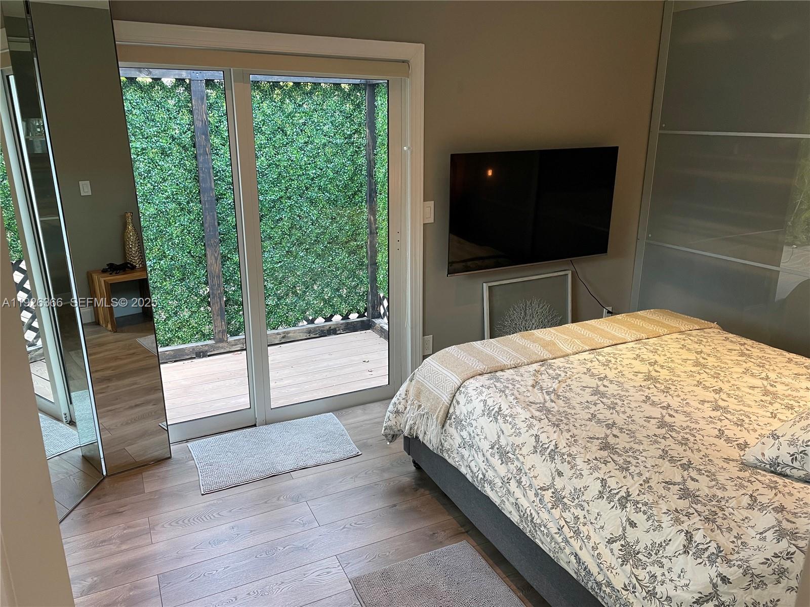 2654 Southwest 25th Terrace Miami, FL 33133 - Photo 19 of 36 a bedroom with a bed and a flat screen tv