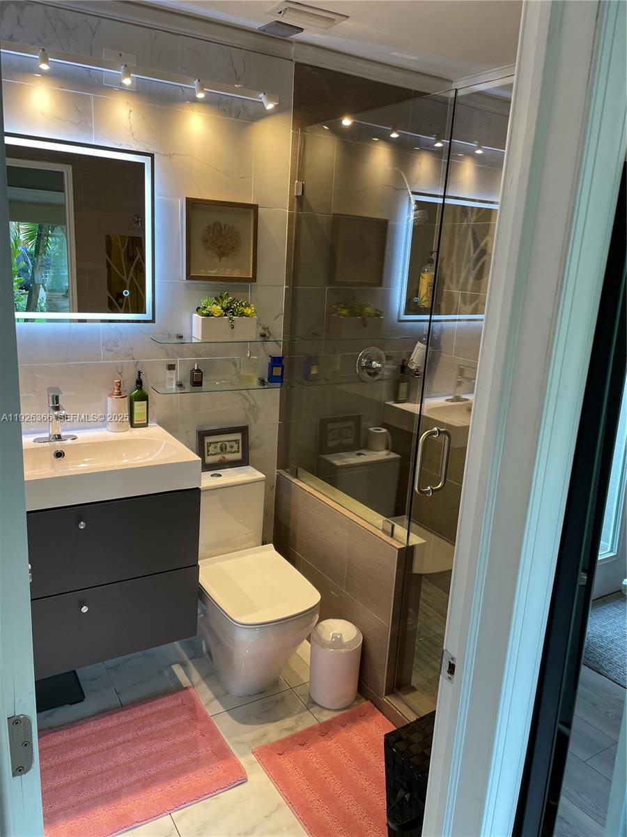 2654 Southwest 25th Terrace Miami, FL 33133 - Photo 23 of 36 a bathroom with a sink toilet and shower