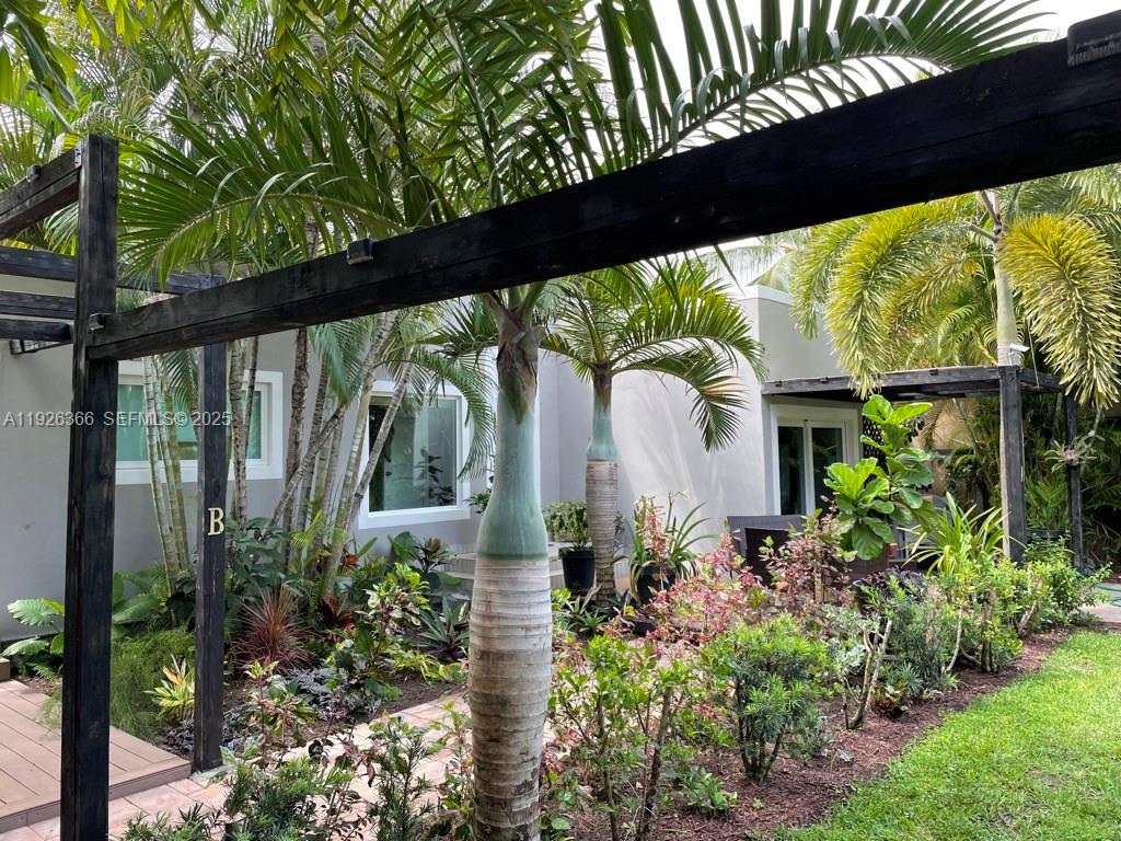 2654 Southwest 25th Terrace Miami, FL 33133 - Photo 31 of 36 a front view of a house with a lots of flower garden