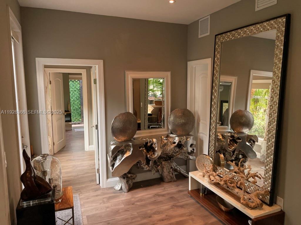 2654 Southwest 25th Terrace Miami, FL 33133 - Photo 5 of 36 a room with lots of wooden furniture and a mirror