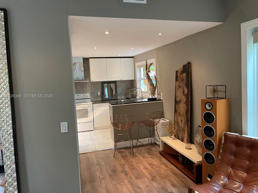 2654 Southwest 25th Terrace Miami, FL 33133 - Photo 9 of 36 a kitchen with stainless steel appliances a refrigerator and cabinets