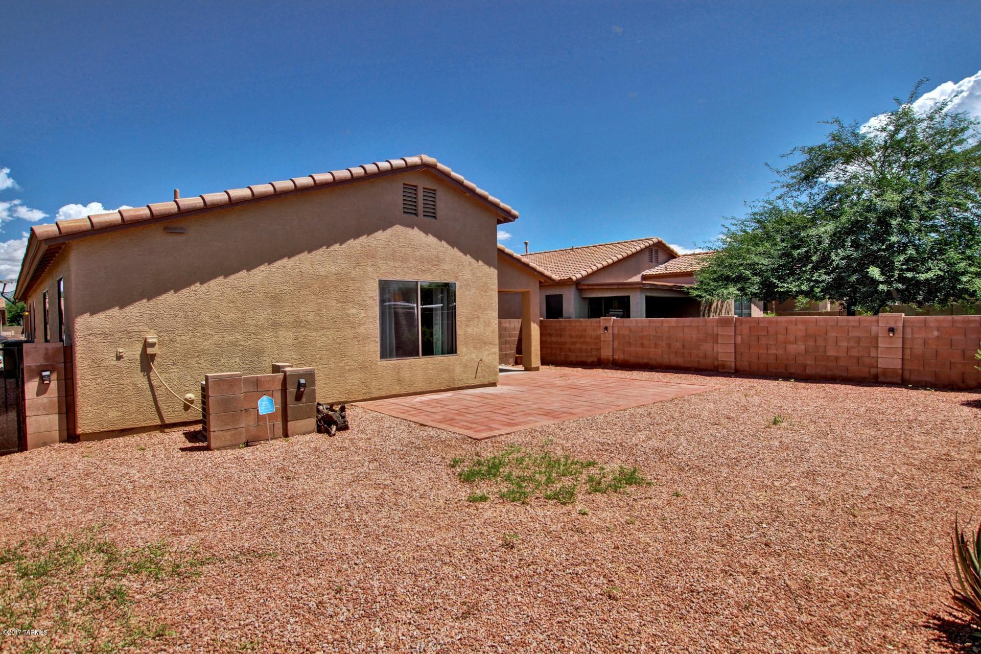 8350 East Bowline Road Tucson, AZ 85710 - Photo 25 of 26 a view of a house with a snow in the yard