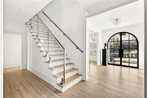 a kitchen with stainless steel appliances kitchen island granite countertop a refrigerator and a sink