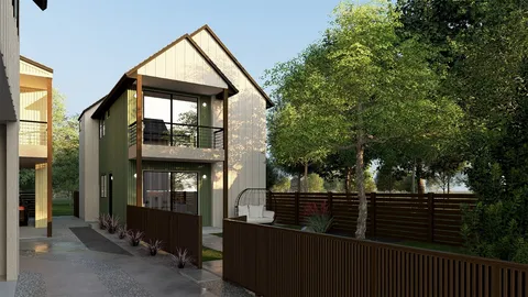 a view of a house with large windows and wooden fence