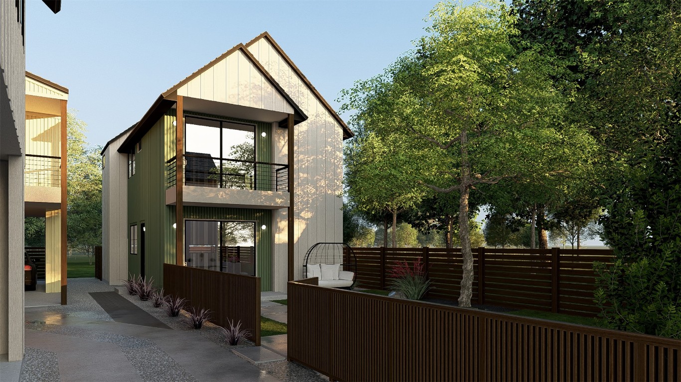 a view of a house with large windows and wooden fence