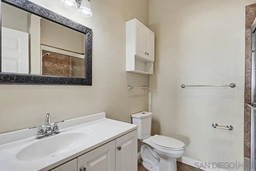 8324 Regents Road, Unit 2E San Diego, CA 92122 - Photo 20 of 31 a bathroom with a sink toilet and vanity