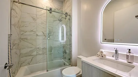 a bathroom with a sink toilet and shower