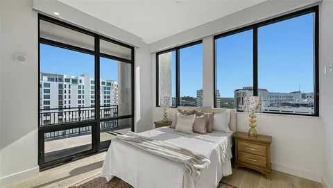 a bedroom with a large bed and a large window