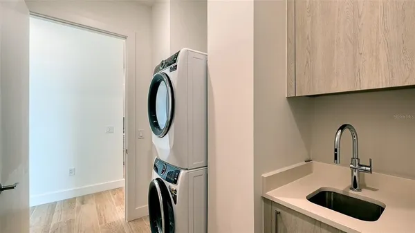 a close view of a sink and dishwasher with wooden floor