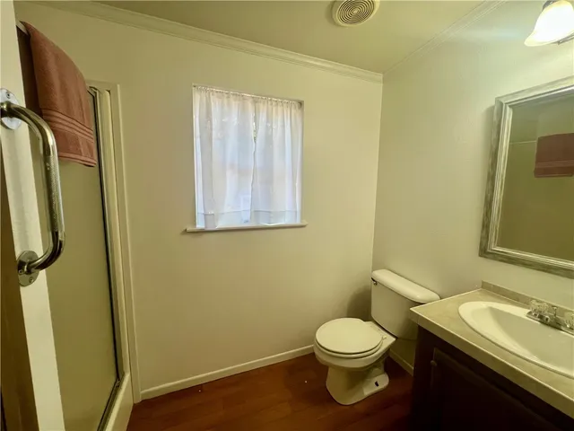a bathroom with a granite countertop toilet sink and mirror