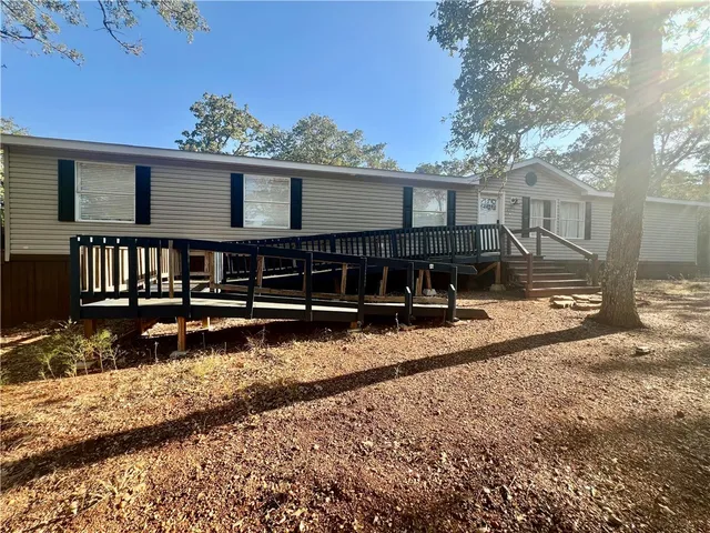 a view of a house with a yard and wooden fence