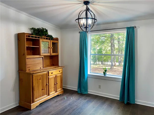 a view of a kitchen with stainless steel appliances granite countertop a stove and a wooden floors