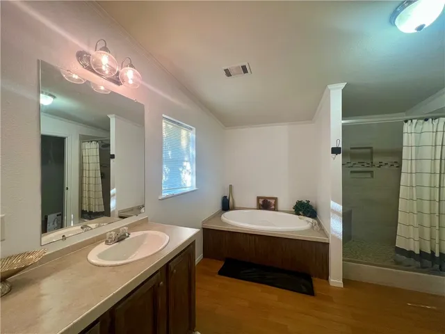 a en suite bathroom with a double vanity sink and a mirror