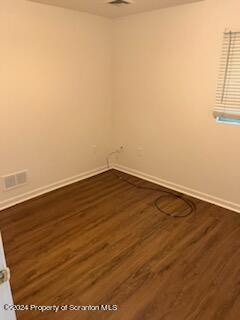 310 New York Street Scranton, PA 18509 - Photo 6 of 10 an empty room with wooden floor and windows
