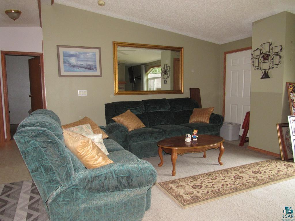 5243 East Neuman Road Superior, WI 54880 - Photo 13 of 35 Carpeted living room with a textured ceiling